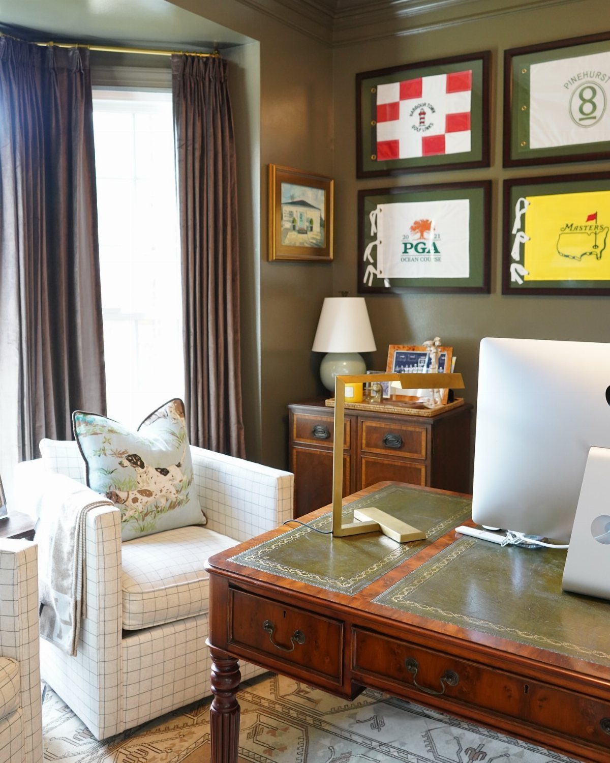 Wooden antique desk with green leather top in a traditional home office setting