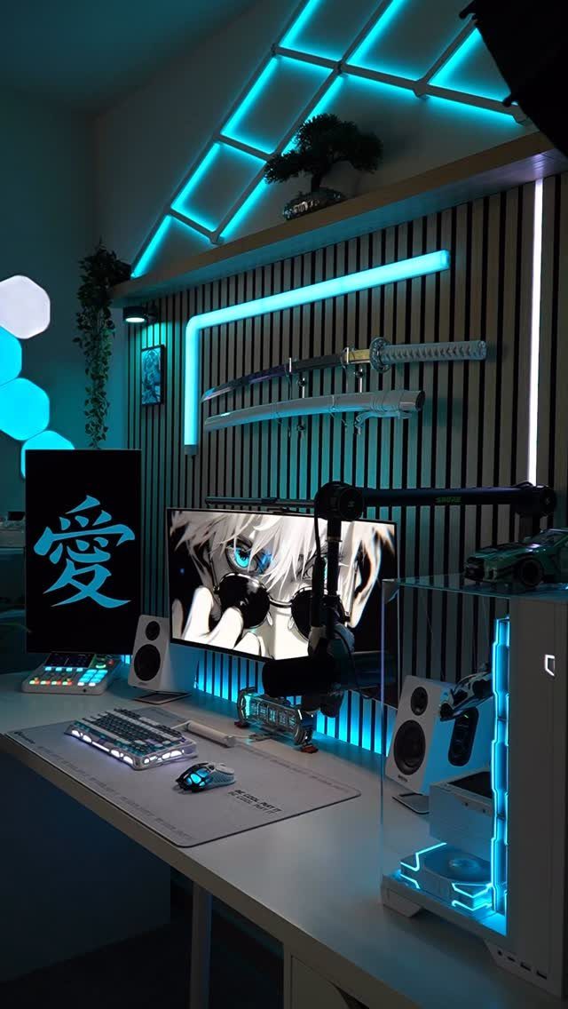 Gaming desk setup with blue LED lighting and a katana on the wall