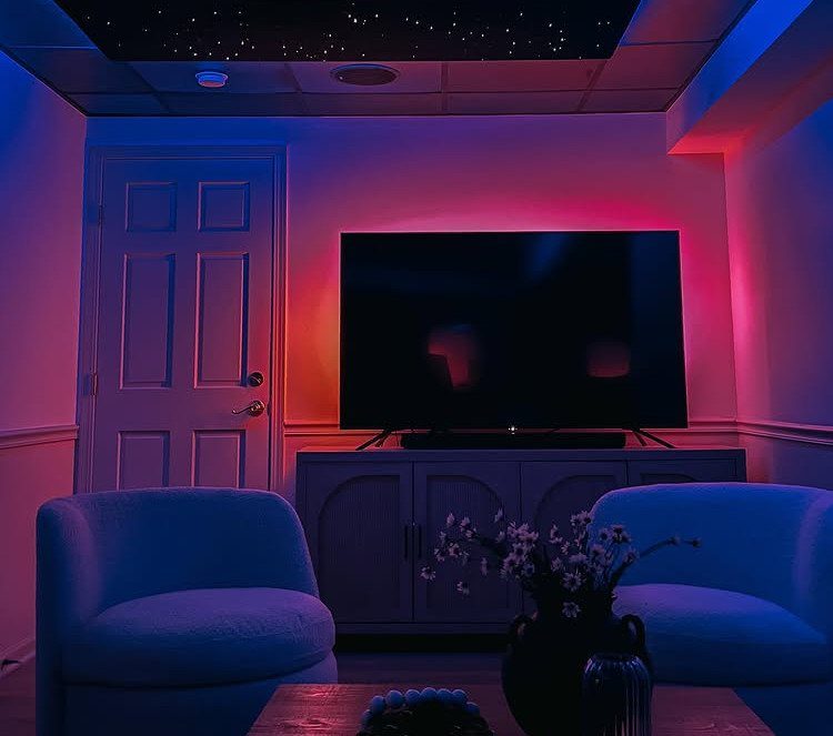 Basement media room featuring a drop ceiling with a starry night light panel.