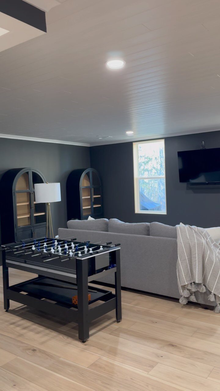 Finished basement game room featuring a white paneled ceiling and foosball table.