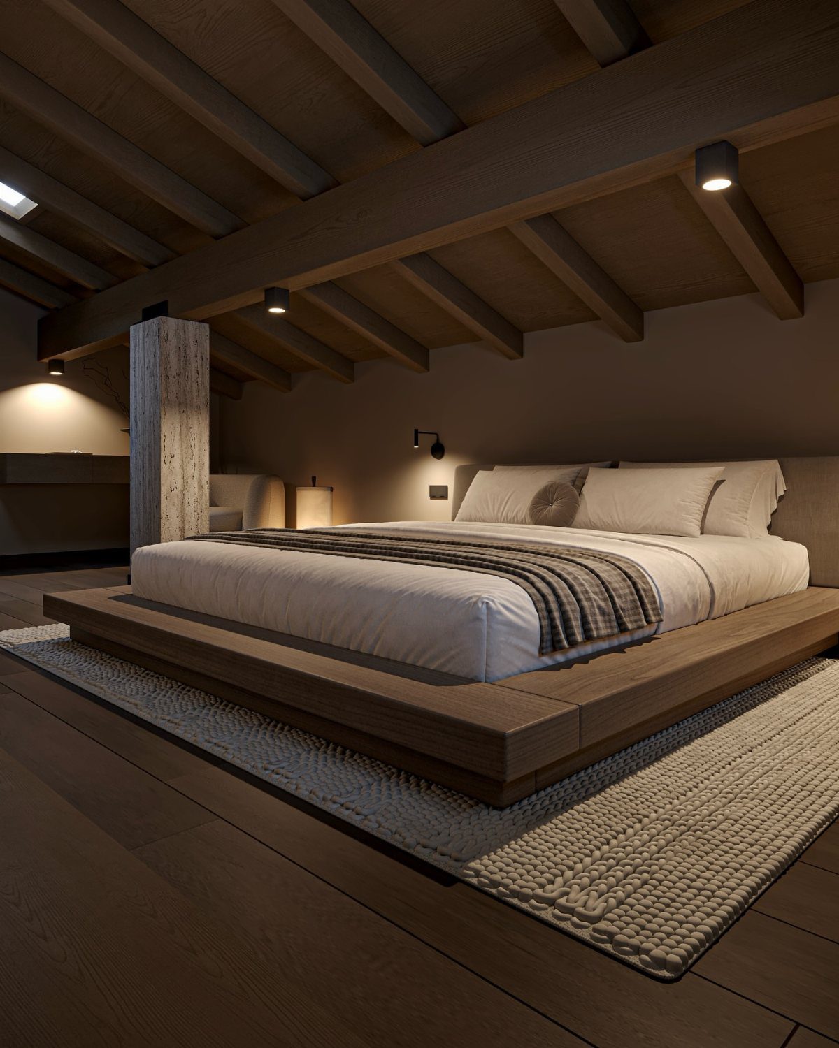 Low platform bed in an attic bedroom with exposed wooden ceiling beams.