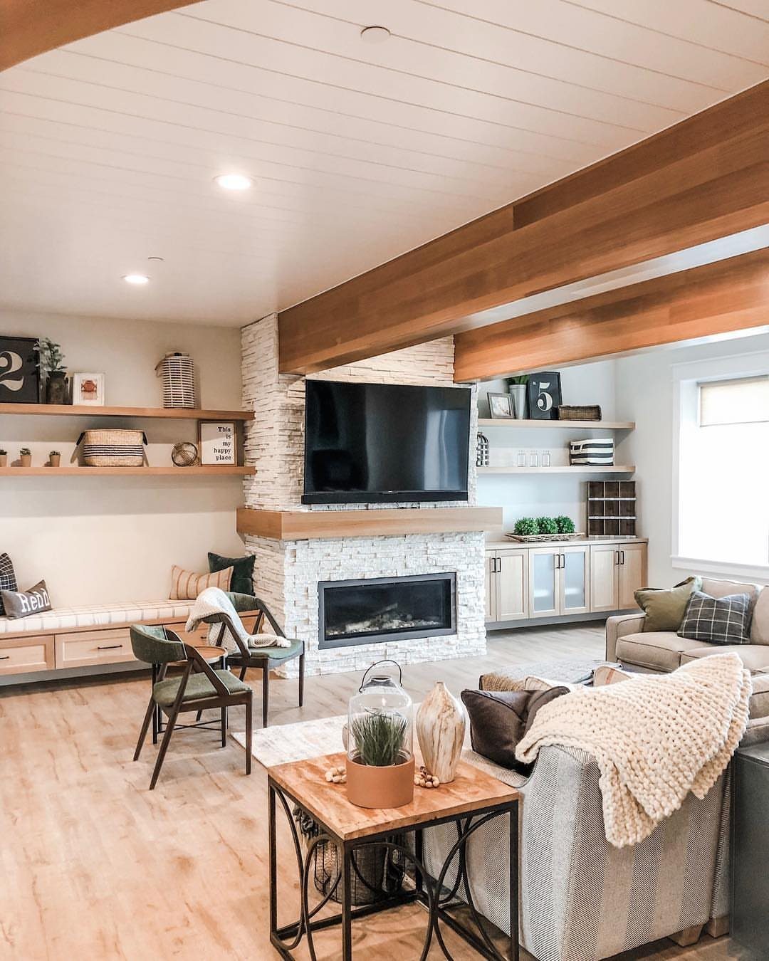 White shiplap ceiling with wooden beams in a modern farmhouse living room