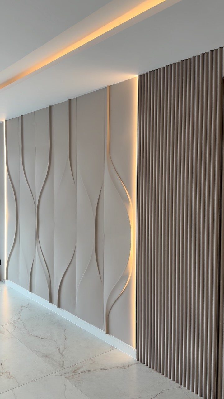 Beige 3D textured wall panels with wave patterns and vertical ribbed slats.