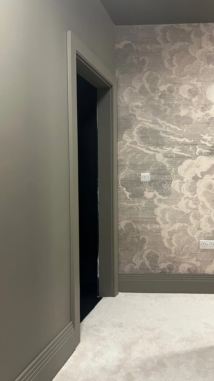 Marbled beige and grey wallpaper on a hallway wall with grey trim.