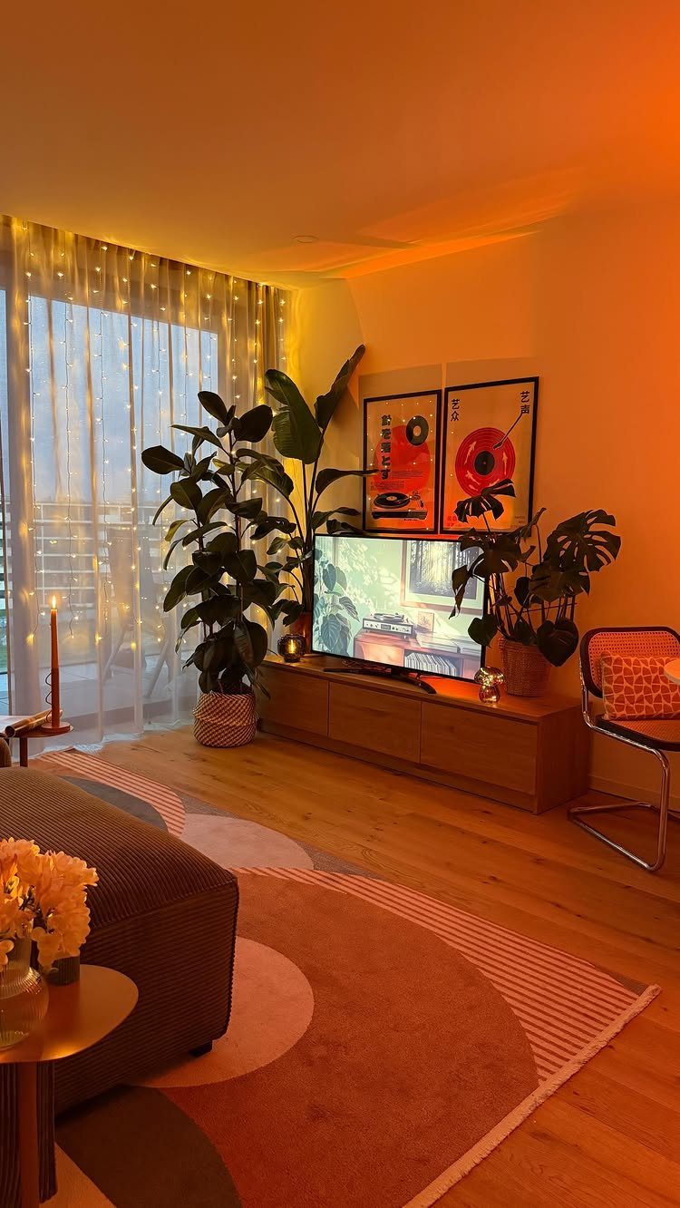 Two framed art prints hanging on a wall above a television and console.