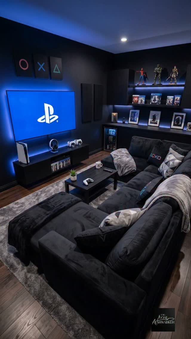 Wall-mounted TV with PlayStation console and blue ambient lighting in a dark gaming room
