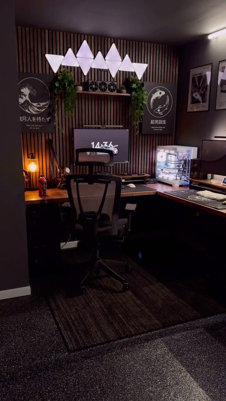Gaming office setup with L-shaped desk, ergonomic chair, and wooden slat wall decor.