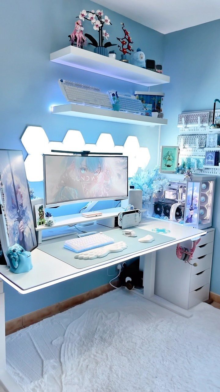 White gaming desk setup with blue walls, hexagonal LED lights, and floating shelves.