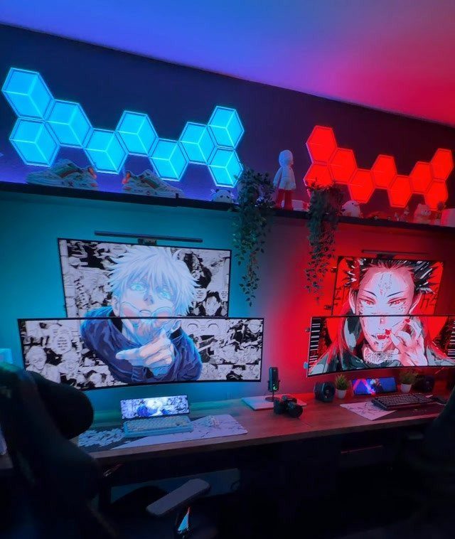 Gaming setup with dual monitors, hexagonal RGB wall lights, and a wooden desk.