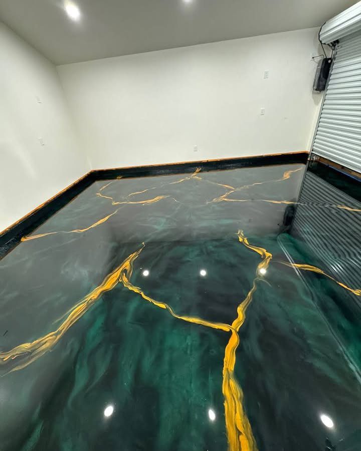 Glossy green and gold metallic epoxy flooring in a clean white garage.