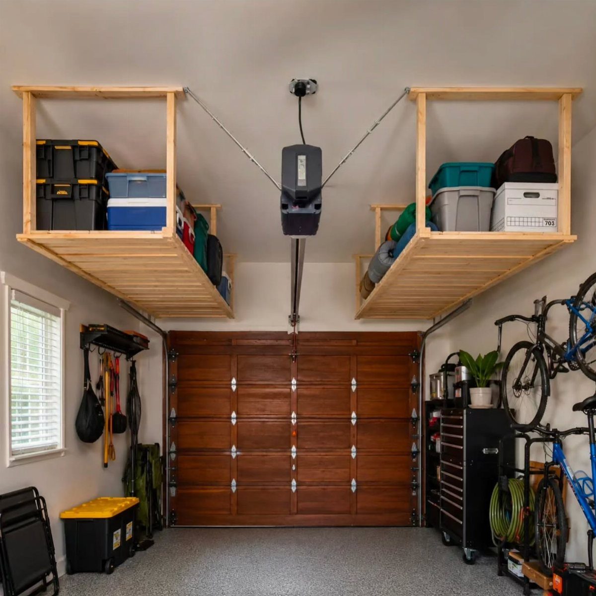 Garage interior with wooden overhead storage lofts and a brown wooden door.