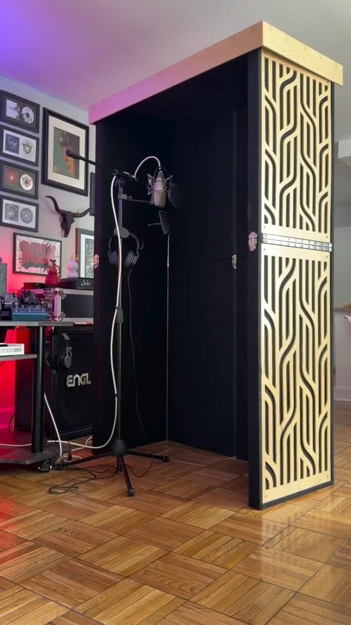 Vocal booth with microphone and wooden diffuser in a home music studio setup