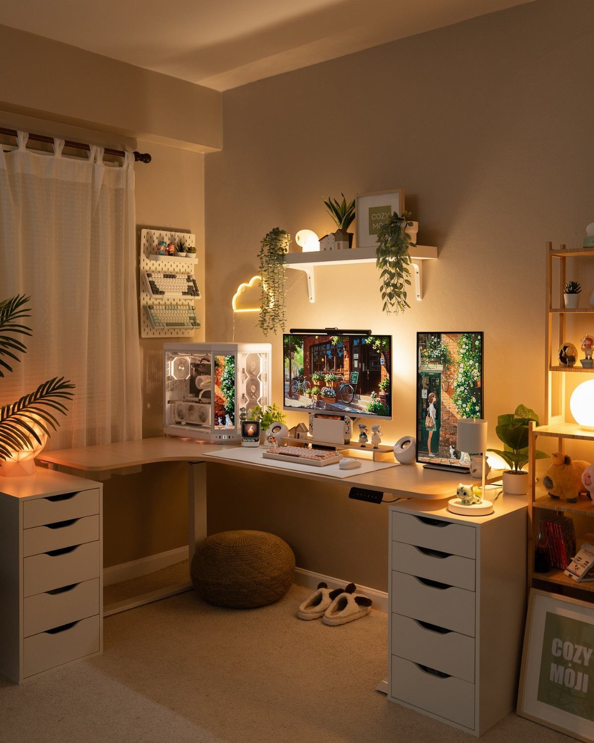 L-shaped home office desk with white drawer units, dual monitors, and decorative plants.