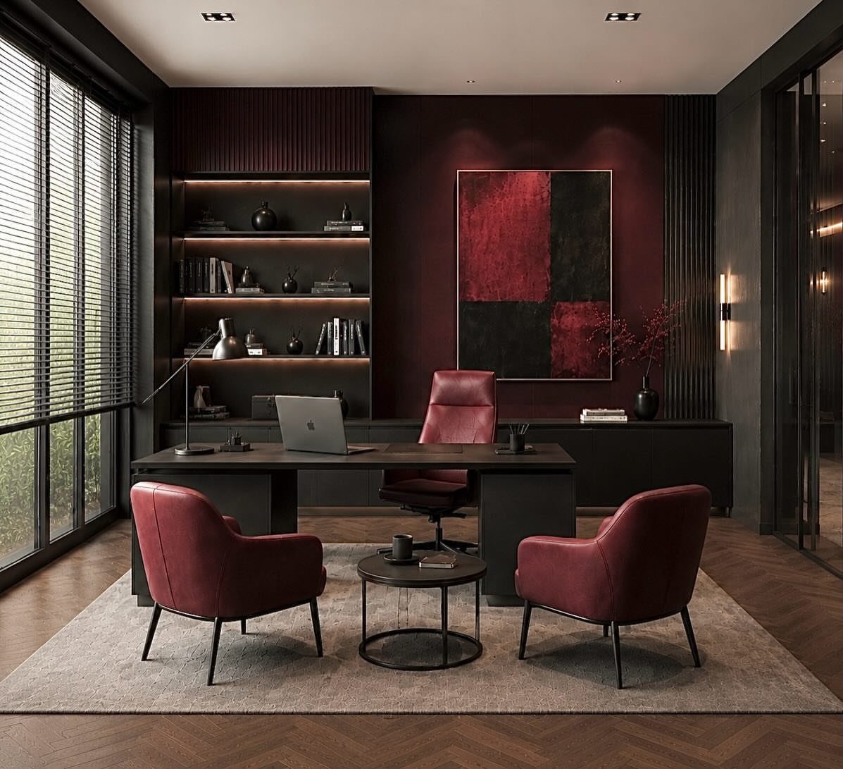 Dark home office with burgundy walls, black desk, and red leather seating.