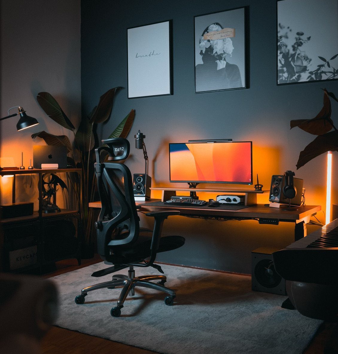 Modern home office with a wooden desk, ergonomic chair, and layered ambient lighting.