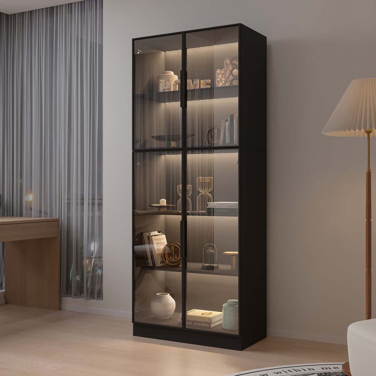 Black-framed glass display cabinet with decorative items on a light wood floor.