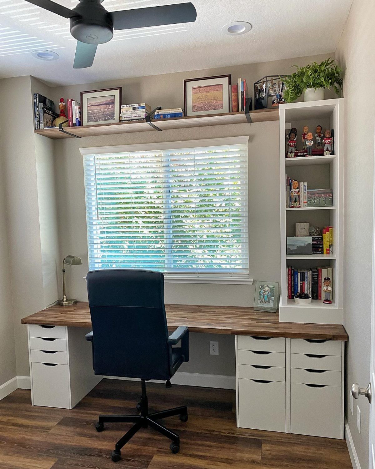 White tall narrow bookshelf next to a wooden desk in a home office