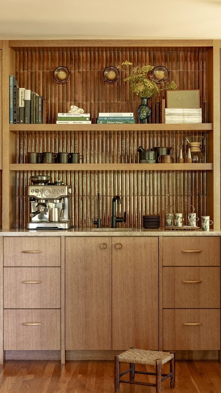 Wooden coffee station with espresso machine, open shelving, and ribbed wood wall paneling.