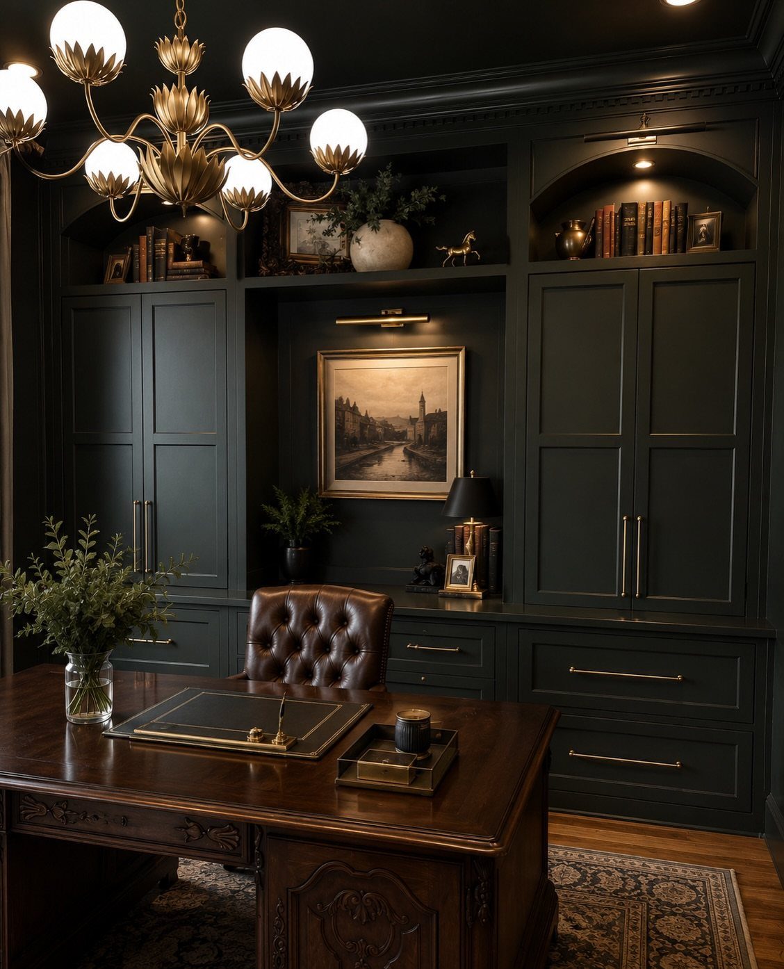 Dark forest green home office with wooden desk, leather chair, and gold chandelier