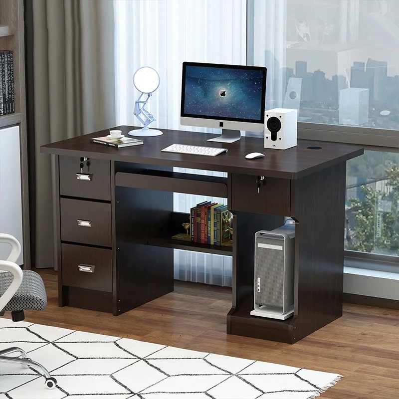 Dark brown wooden computer desk with monitor and accessories on a geometric rug