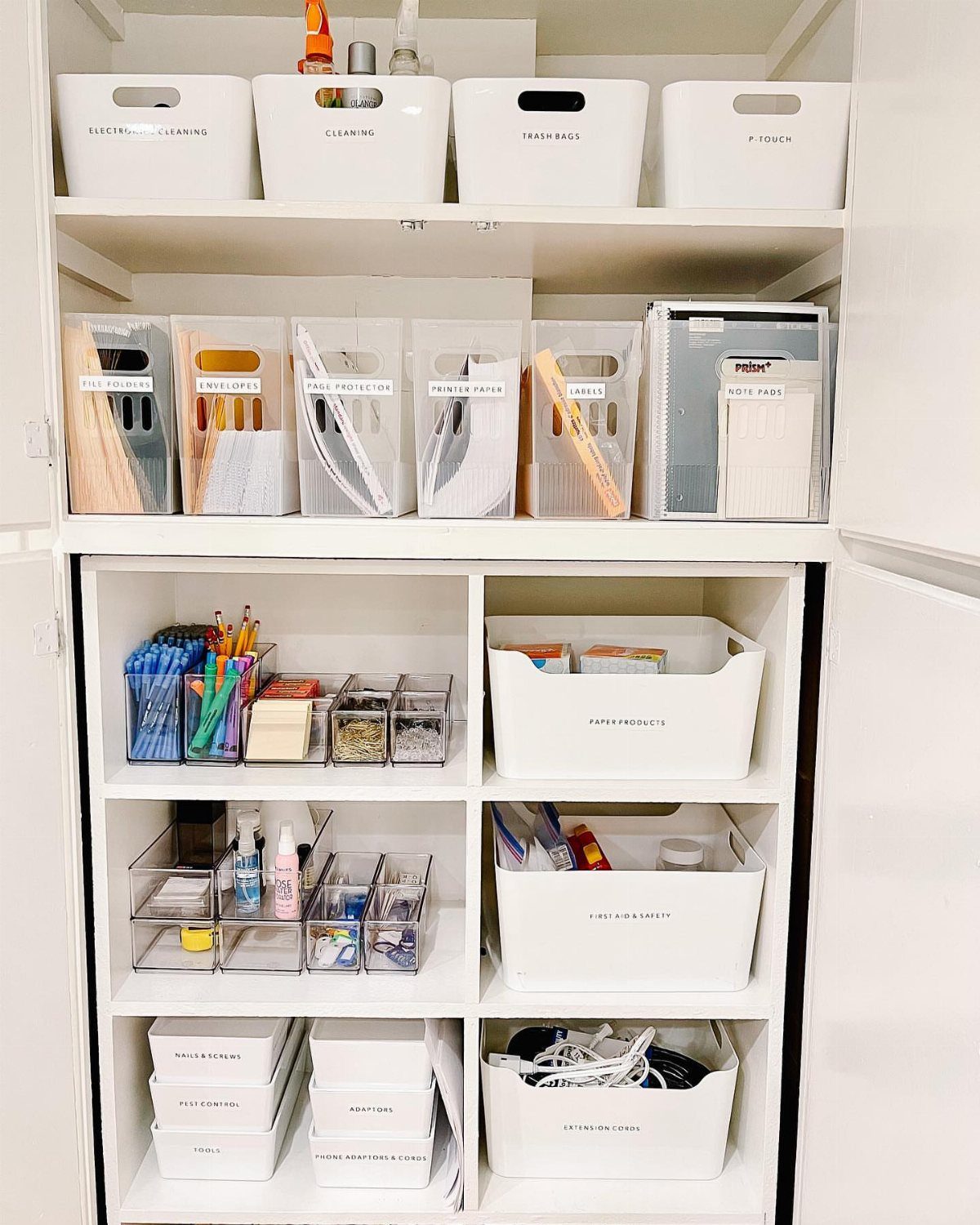 White shelving unit with organized bins, clear folders, and office supply containers.