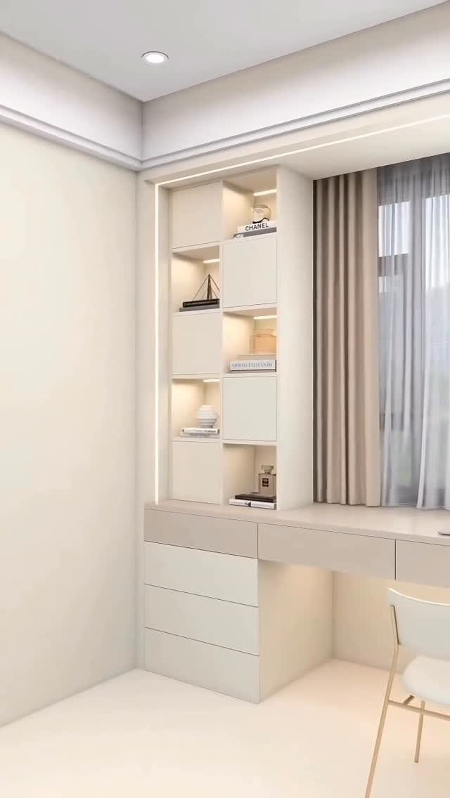 White built-in desk with an integrated backlit shelving unit in a modern office.