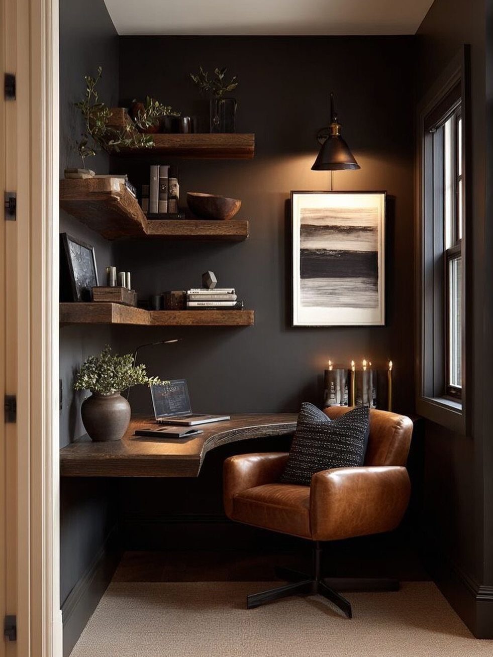 Curved wooden corner desk in a dark home office with leather chair