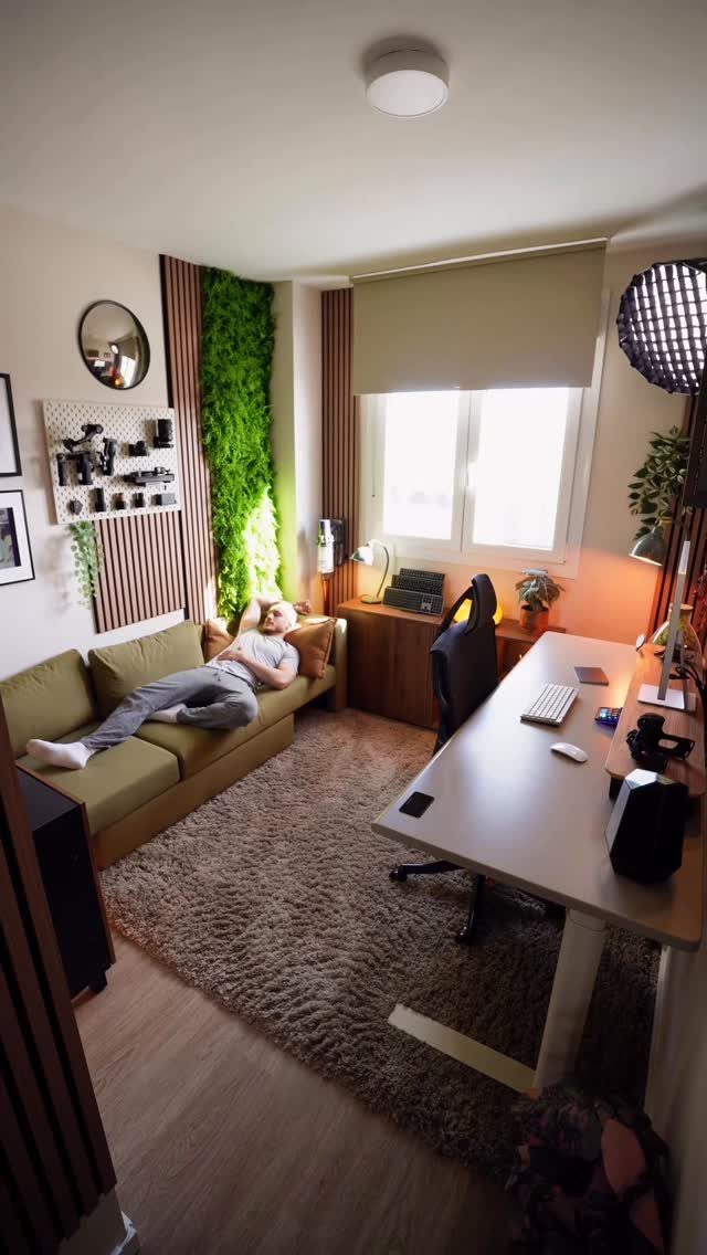 Modern home office with a white desk and a green sofa for lounging.