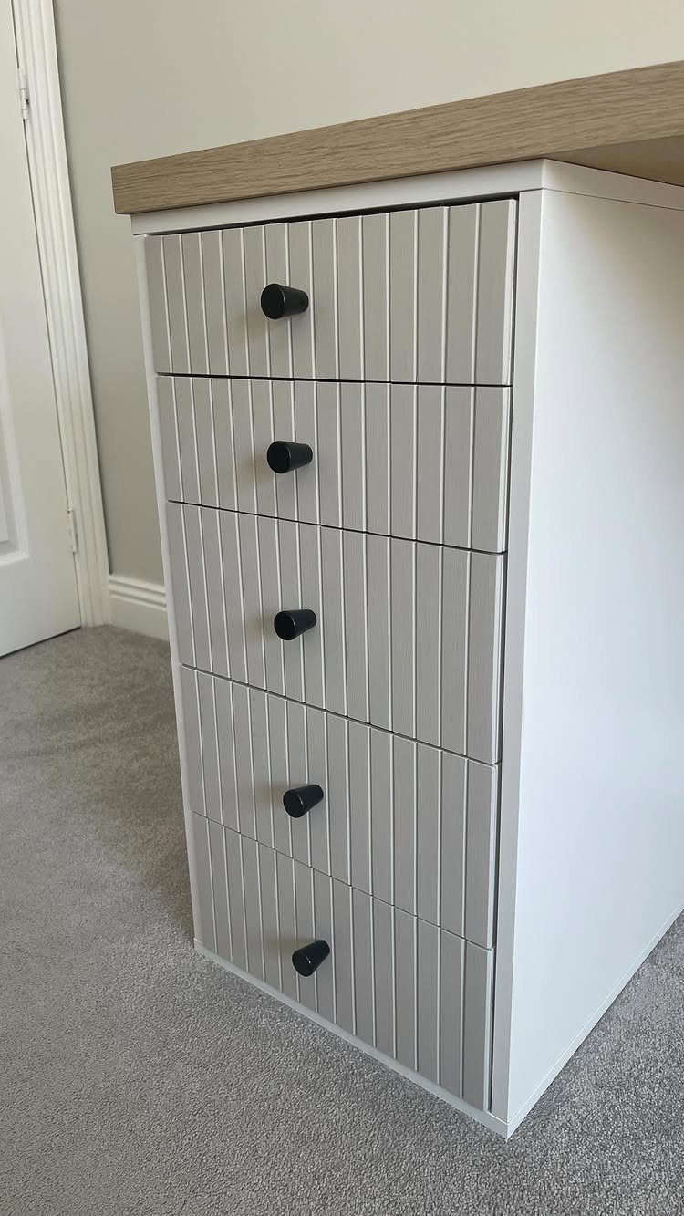 White ALEX drawer unit with grey painted slatted drawer fronts and black knobs.