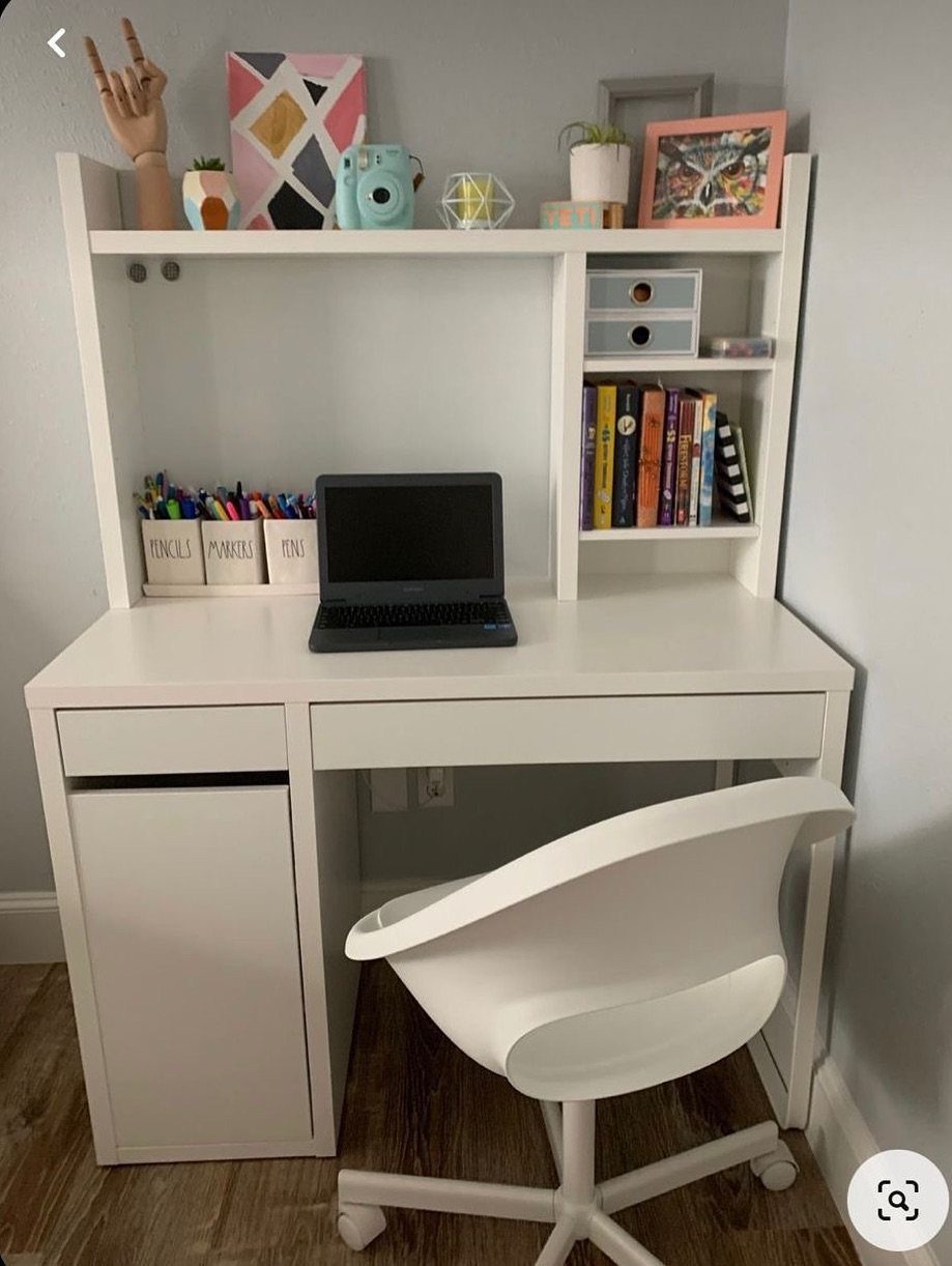 White desk with hutch and shelving holding a laptop and books with chair.