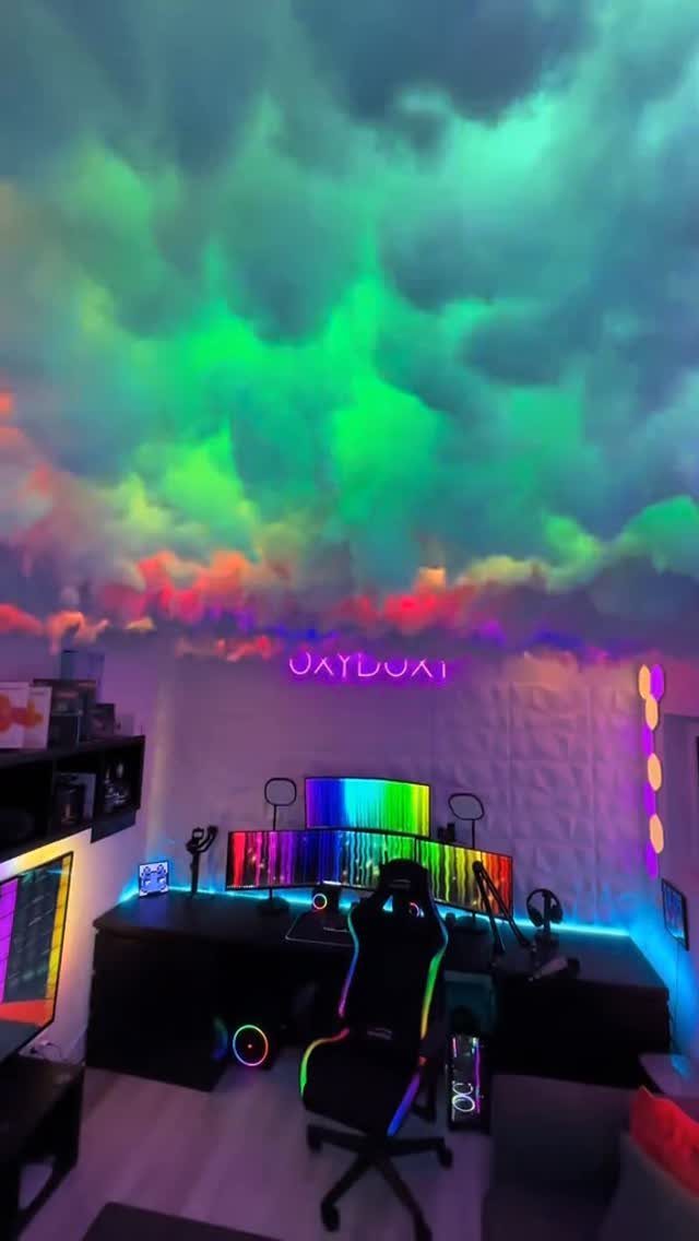 Cloud ceiling with colorful LED lighting above a professional gaming computer setup