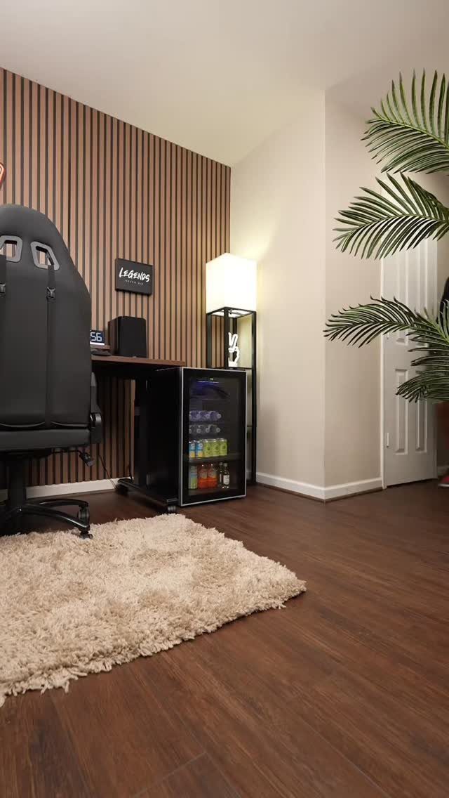 Black mini fridge filled with drinks in a modern gaming room setup