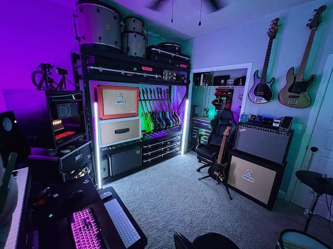Music room with electric guitars, amplifiers, drums, and purple LED accent lighting.