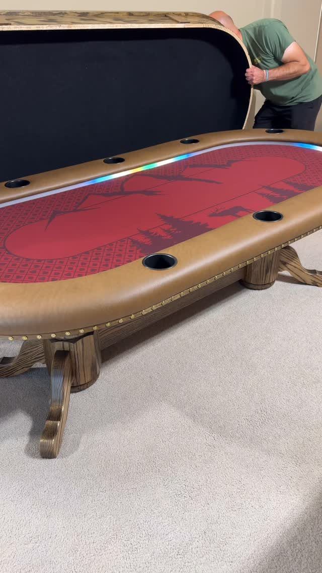 Wooden game table with red felt top and cup holders in a room