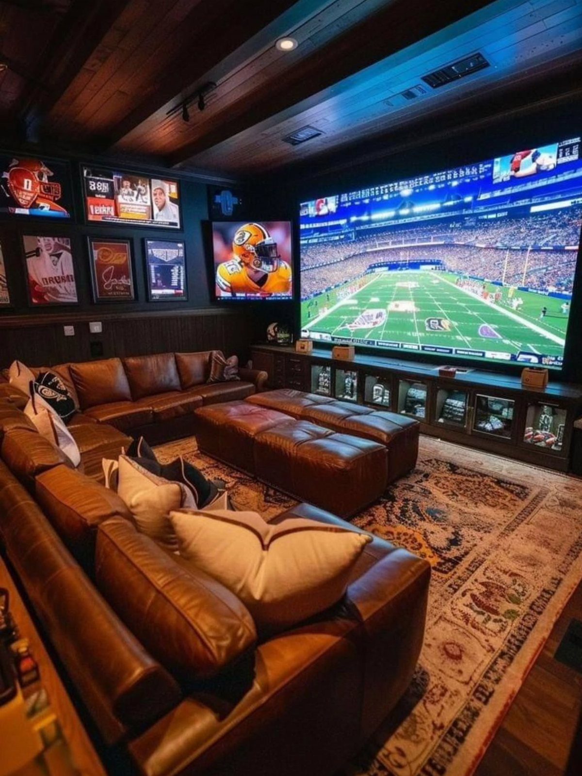 Brown leather sectional sofa in a man cave with a giant football screen.