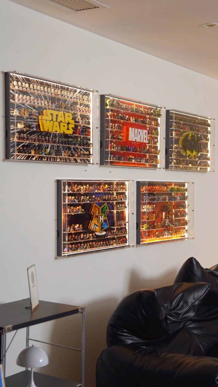 LEGO minifigure display cases mounted on a wall featuring Star Wars and Marvel themes.