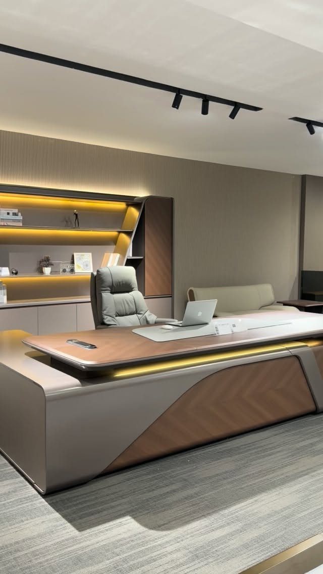 Modern office desk with ergonomic chair, laptop, and warm integrated LED lighting.