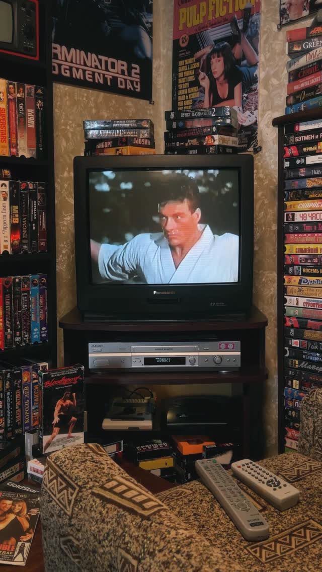 CRT television and VHS collection in a nostalgic retro home movie room setup