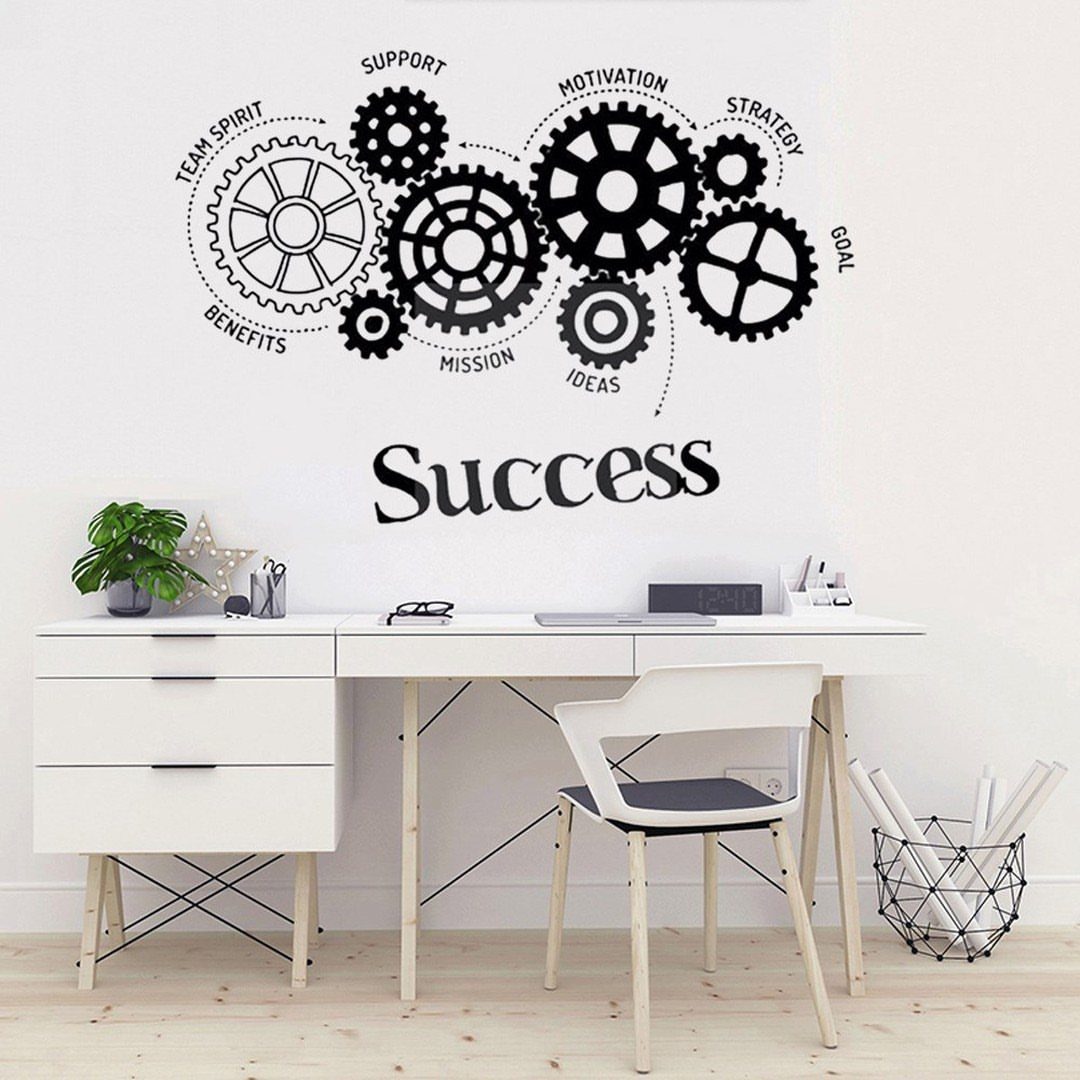 White office desk with a black gear-themed adhesive graphic on the wall above.
