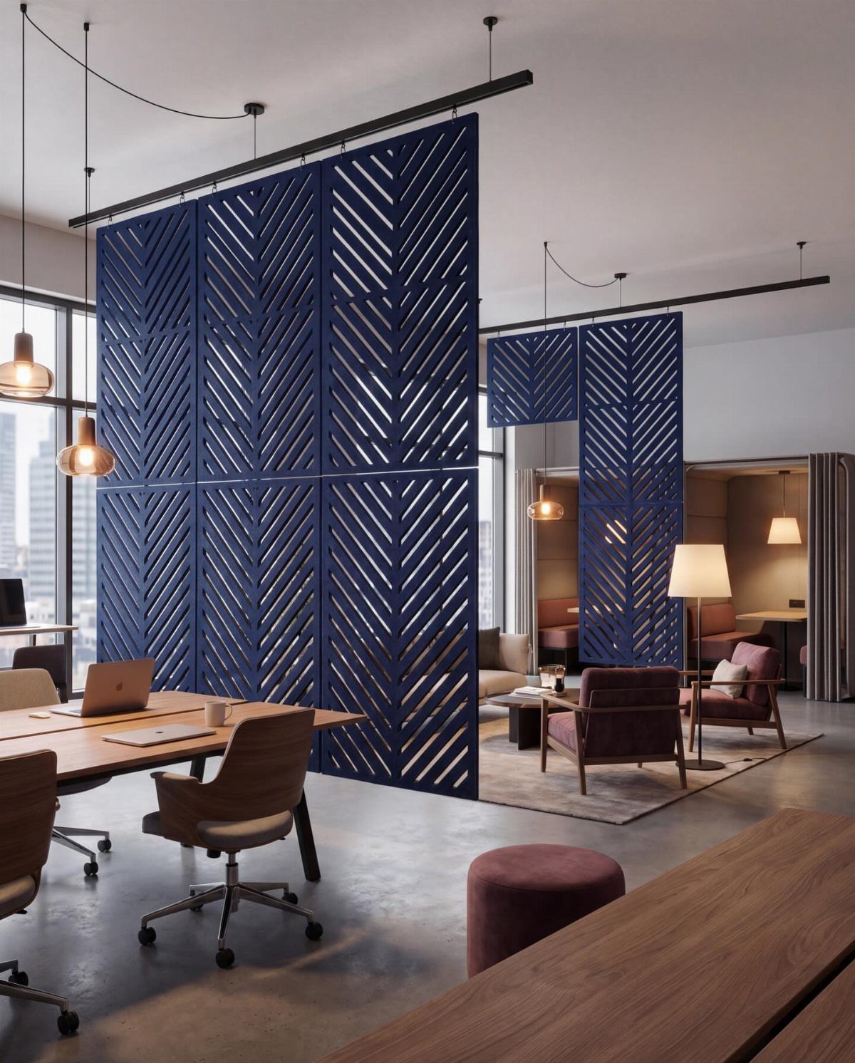 Blue geometric room dividers separating a wooden desk area from a lounge space.
