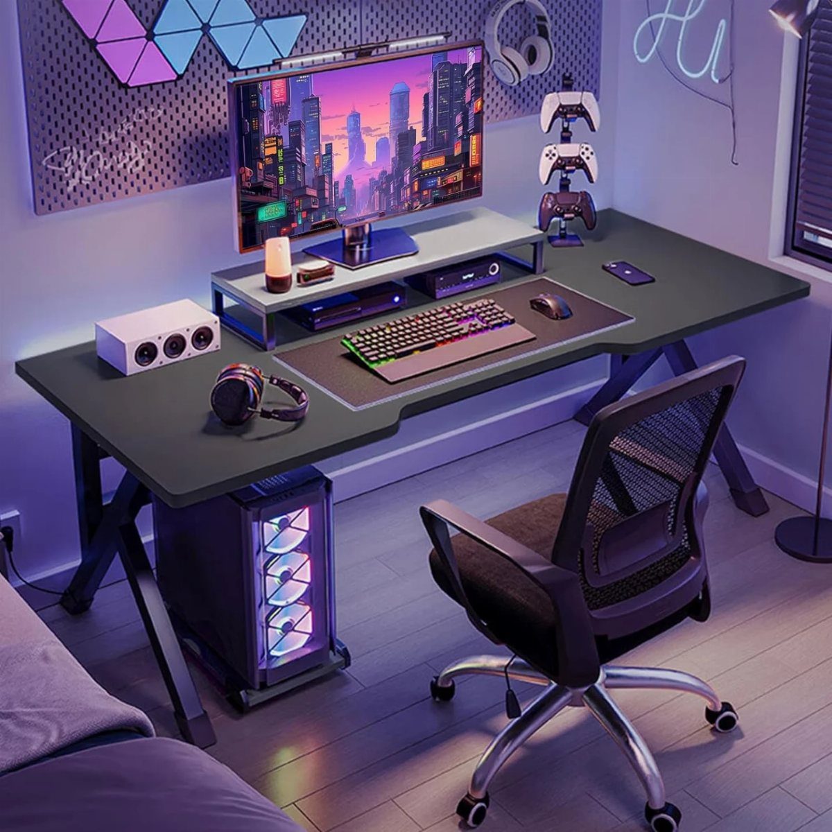 Gaming desk setup with RGB PC, large monitor, and ergonomic chair in purple lighting