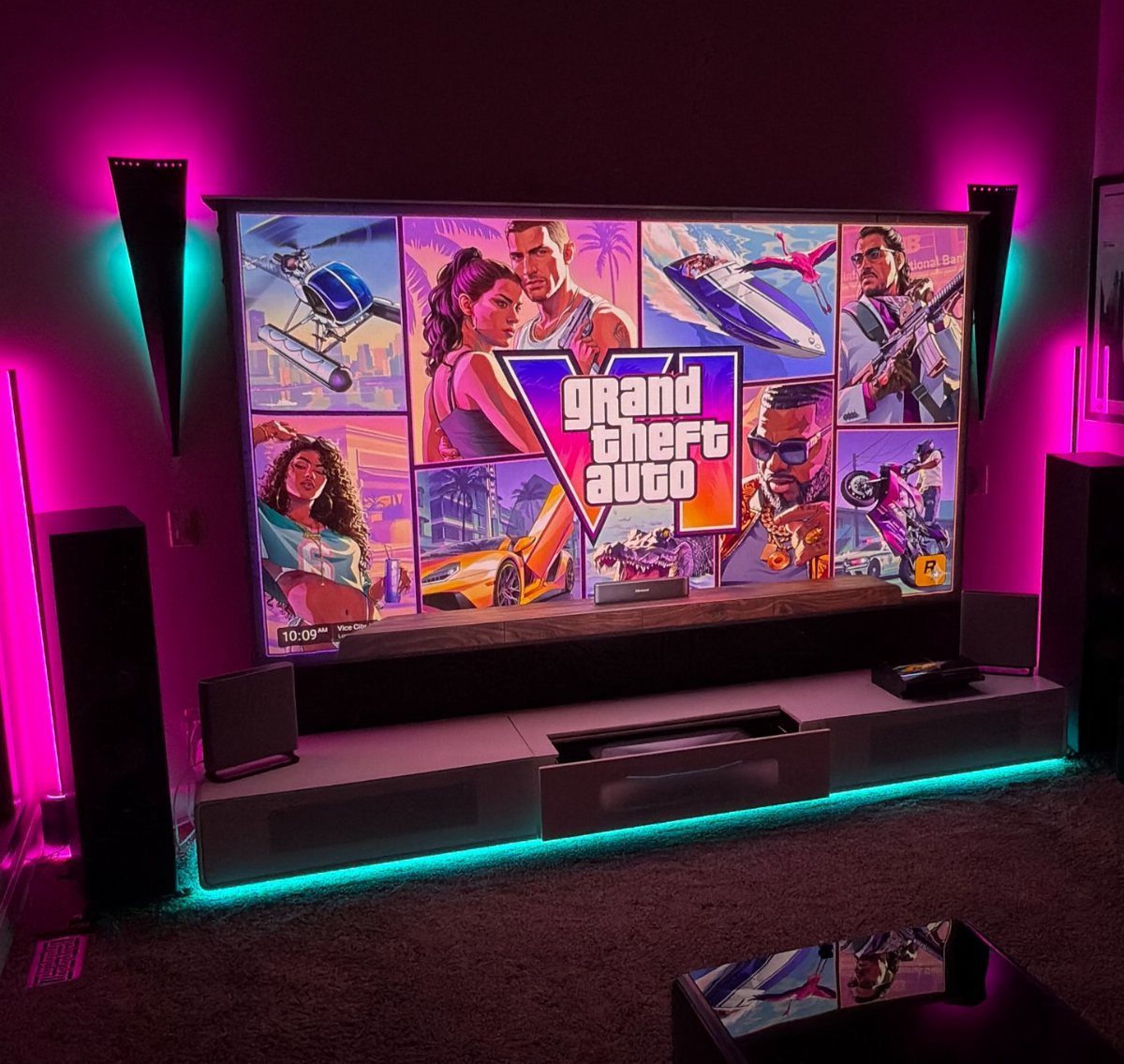 Large television with gaming art and neon LED lighting in a dark room