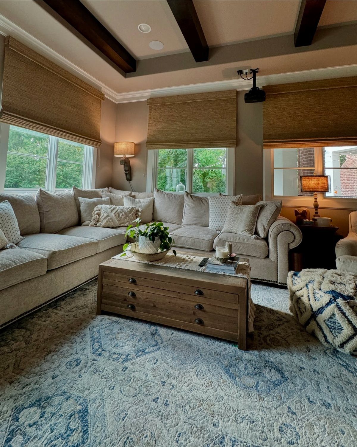 Beige sectional sofa and wooden coffee table in a decorated rec room