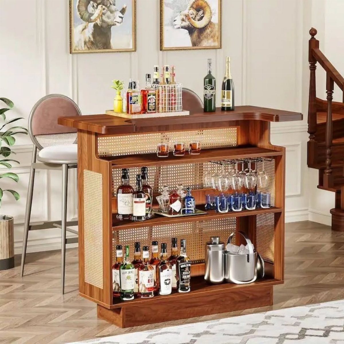 Wooden home bar cabinet with liquor bottles, glassware, and an ice bucket.