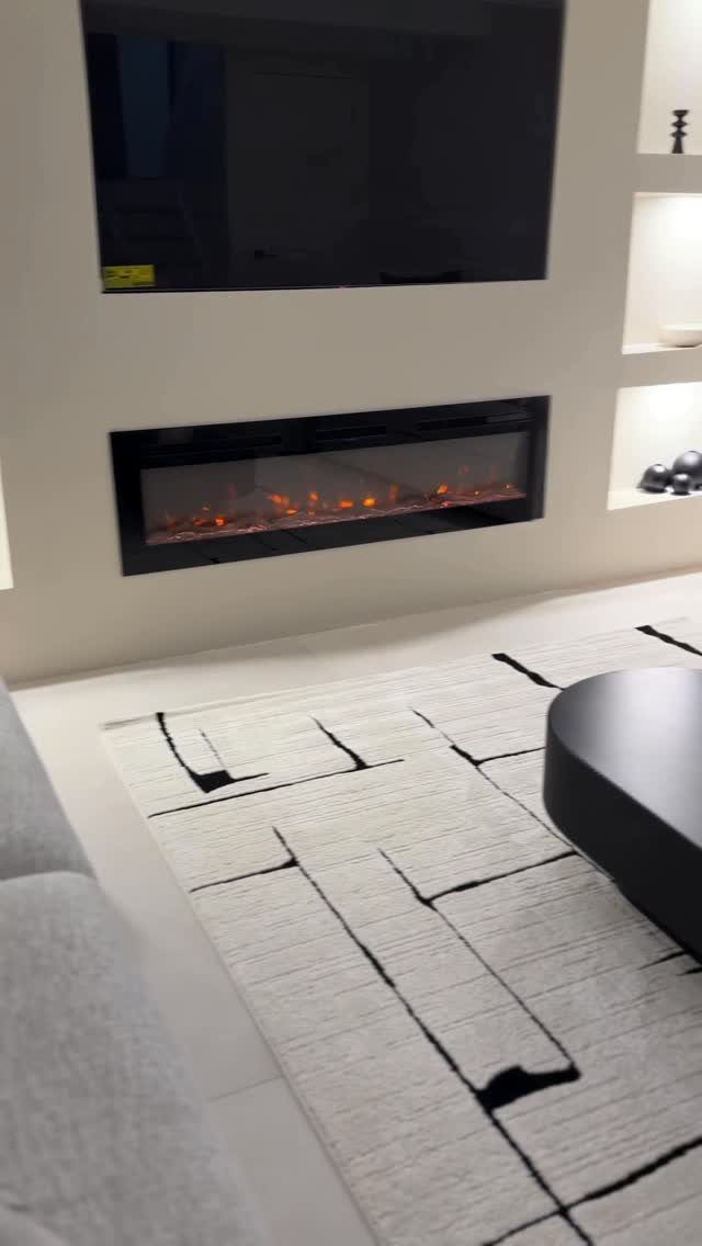 White area rug with black geometric patterns in a modern living room setting
