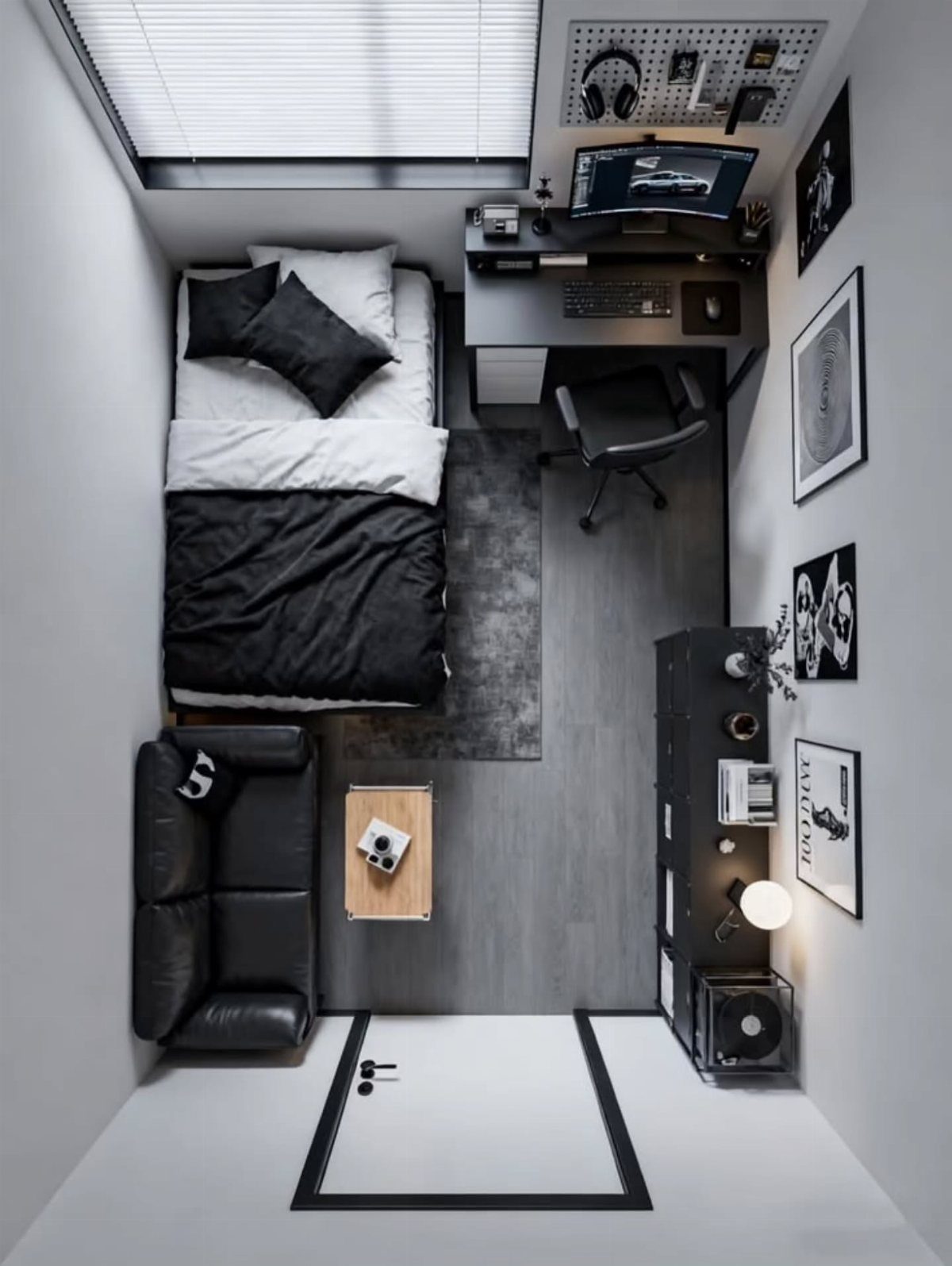 Small modern bedroom with black leather sofa, gaming desk, and grey bedding.