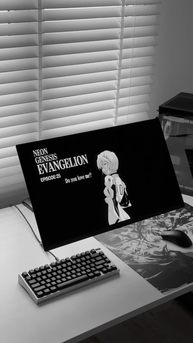 Computer gaming setup with mechanical keyboard and anime wallpaper on a white desk