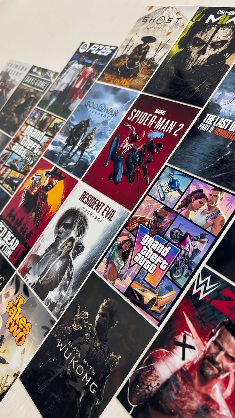 Video game cover art prints arranged in a grid on a white wall.