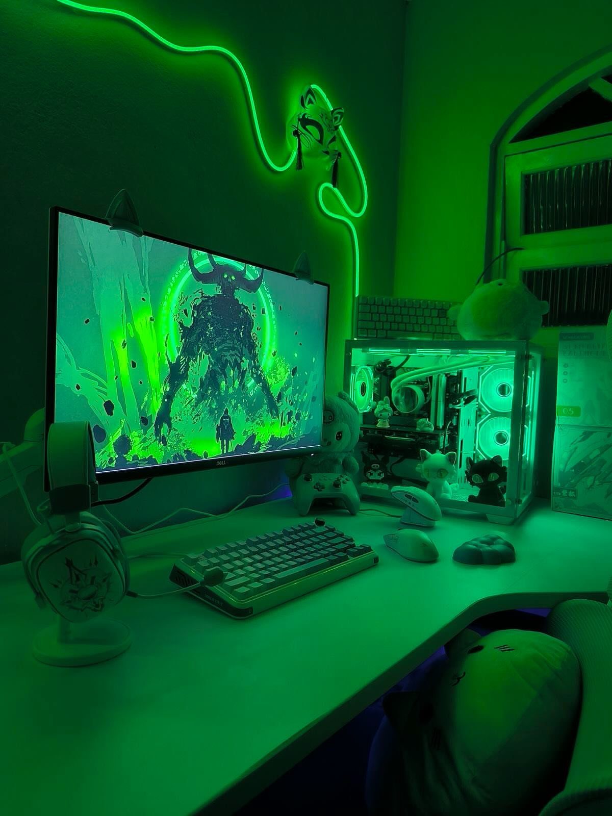 Gaming setup with white furniture and vibrant green neon lighting and accents.