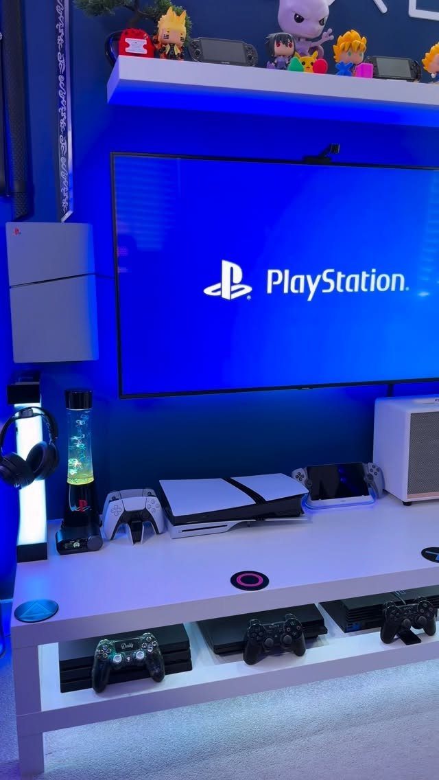 PlayStation gaming setup with blue ambient lighting, white console table, and floating shelf.